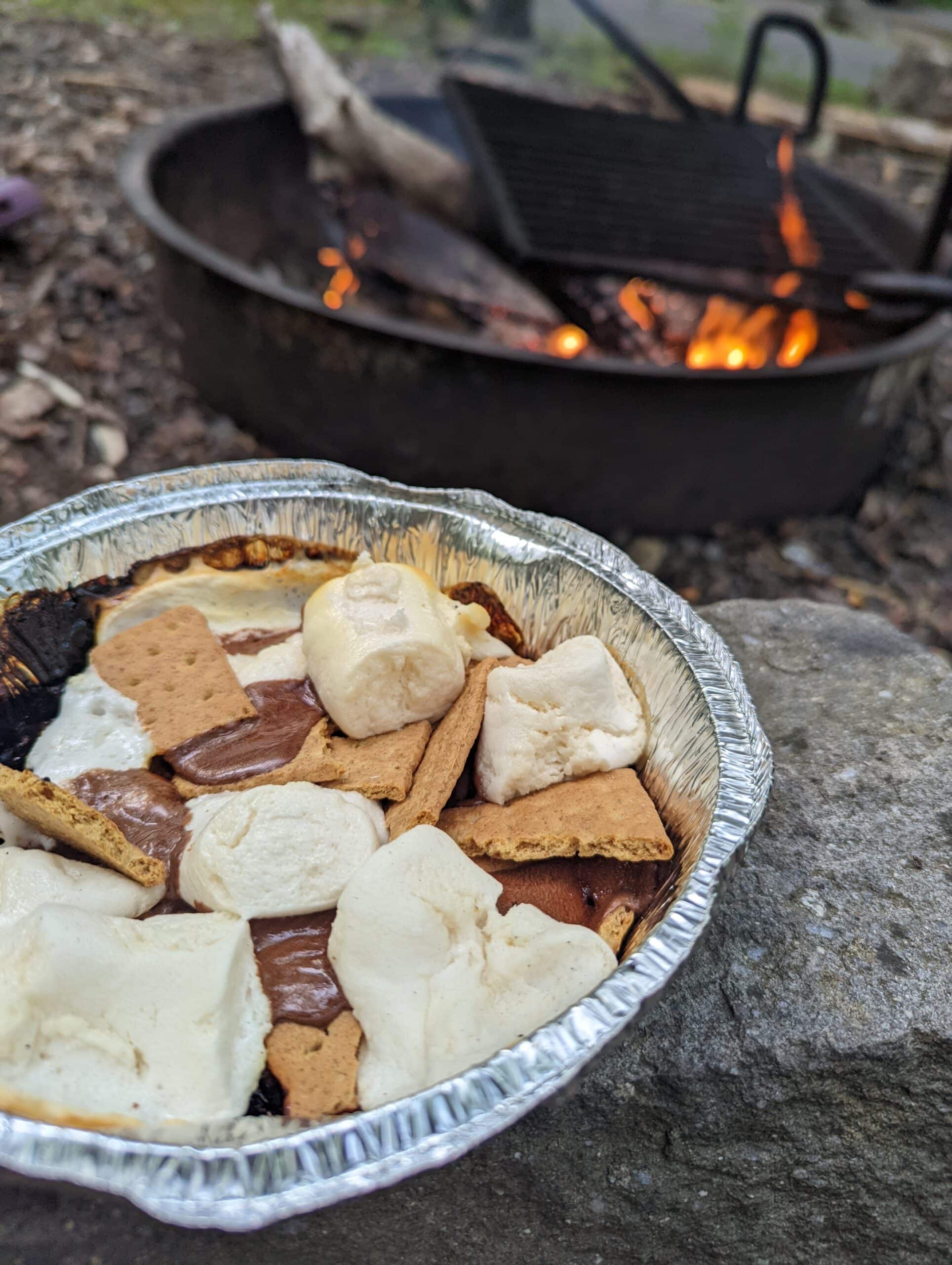 deconstructed camping s'mores in an aluminum tin instead of on a s'mores stick