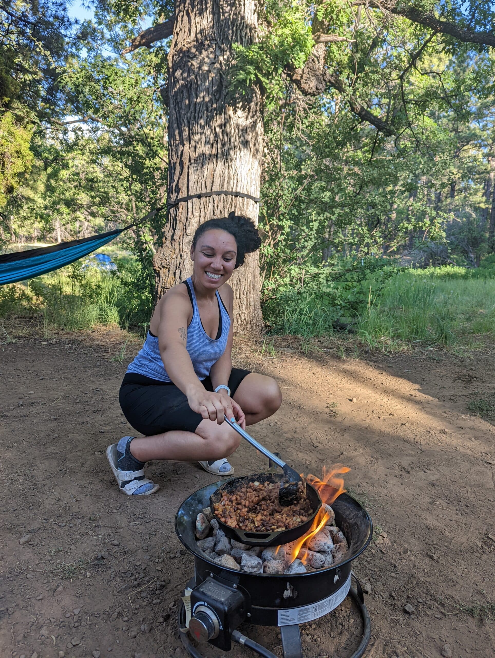 cooking vegan lunch camping over a fire
